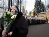 42. A woman carries flowers in front of a residence of Patriarch Alexy II, the head of the Russian Orthodox Church, outside Moscow on December 6, 2008. Alexy, 79, died at his secluded residence. No cause of death was announced officially, but state news agency RIA Novosti, quoting Church sources it did not name, said he had died of a heart attack. The funeral of Patriarch Alexy II is expected to take place in Moscow on December 9, 2008. (From Getty Images by AFP/Getty Images)