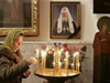 56. A Belarusian Orthodox believer lights a candle in a church in front of a portrait of Russian Orthodox Church Patriarch Alexy II, in Minsk, Belarus, Friday, Dec. 5, 2008. Russian Orthodox Patriarch Alexy II, who presided over a vast post-Soviet revival of faith but struggled against the influence of other churches, died Friday at age 79. (From AP Photo by SERGEI GRITS)